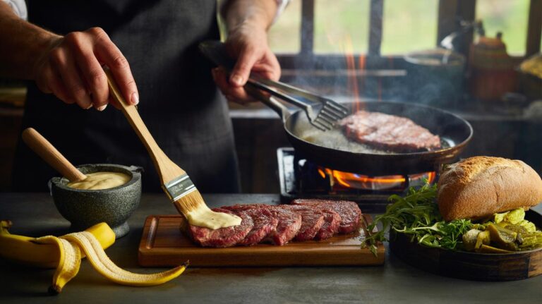 Illustration of banana peel enzyme marinade tenderising thin-sliced meat in 10 minutes for a sandwich, with a hot pan ready for searing